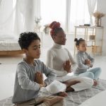 Mom meditating with her children