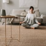 Woman meditating in her living room